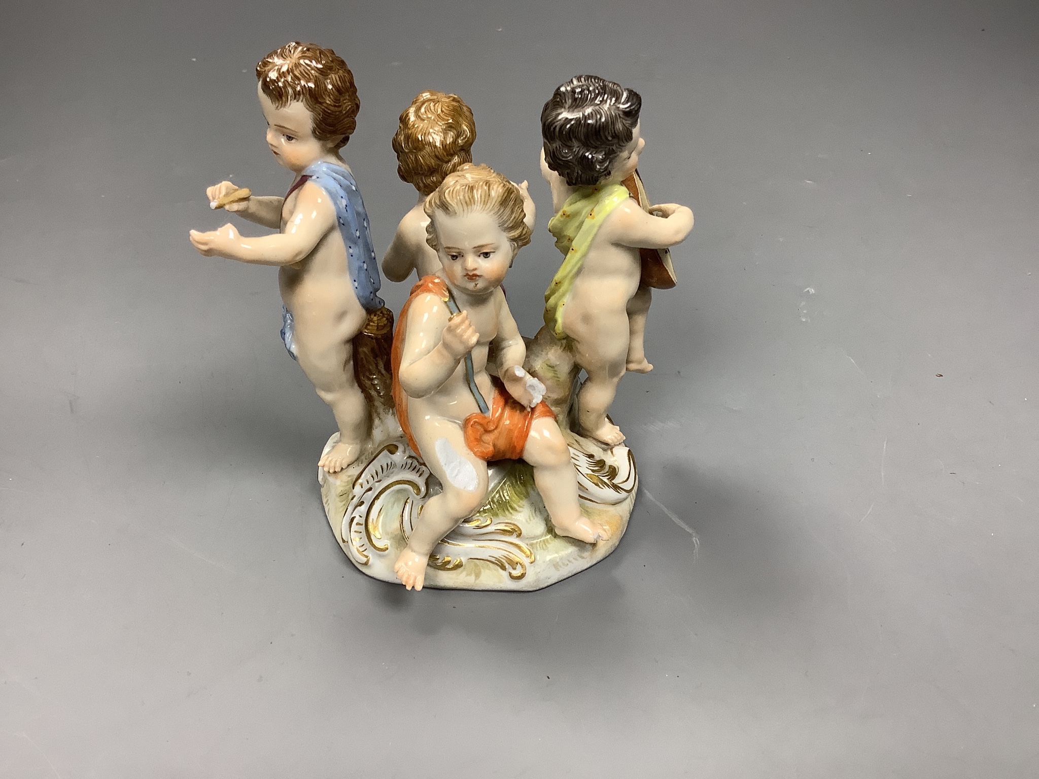 A Meissen group of four putti musicians, late 19th century, 11 cm high, losses